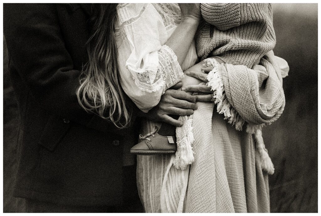 black and white family portrait Missouri close up of hands holding baby