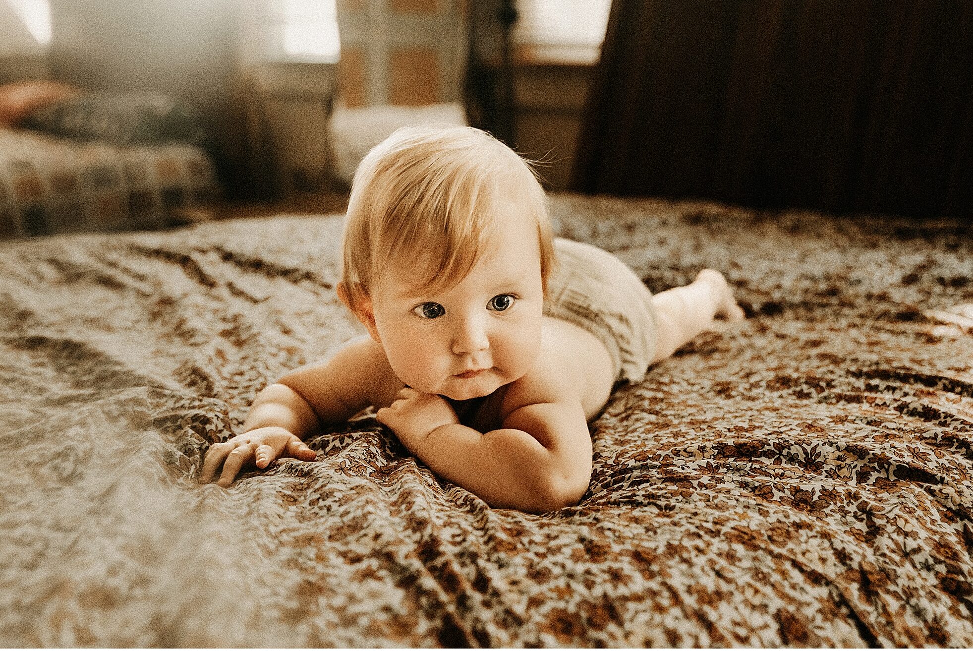 baby laying on bed motherhood session in home lifestyle family photographer St Peters Missouri