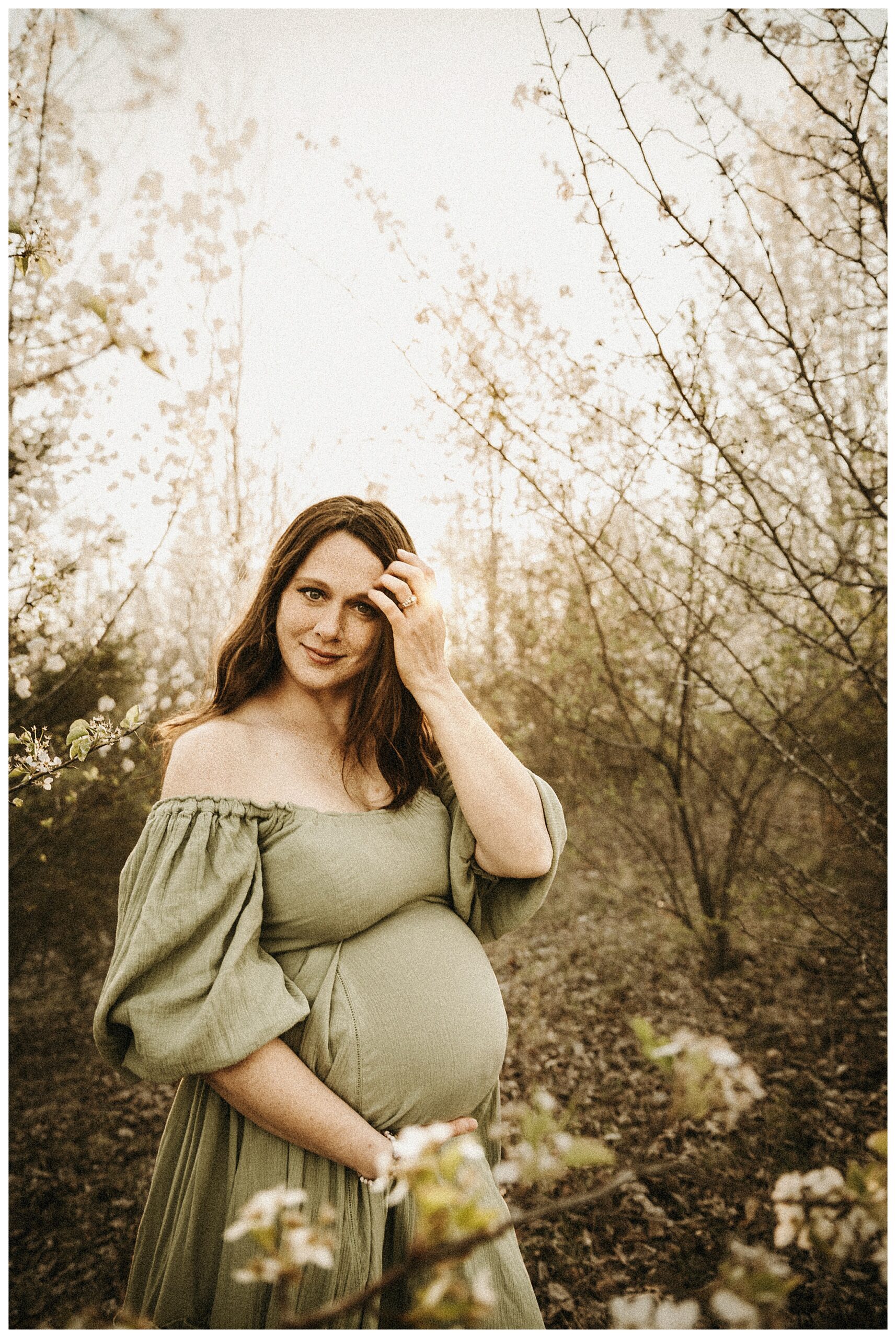 expecting mother in Missouri blooming trees in spring outdoor family session with sunset in background, vintage looking family photographer O'fallon Missouri