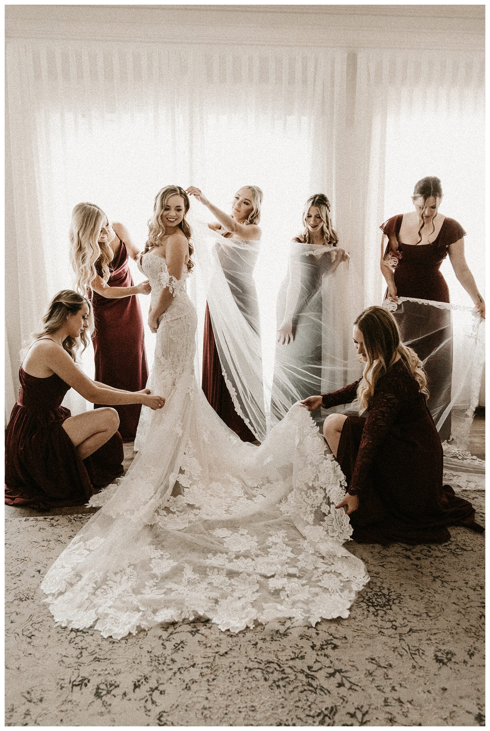 bridesmaids helping bride getting dresses Silver Oaks Chateau