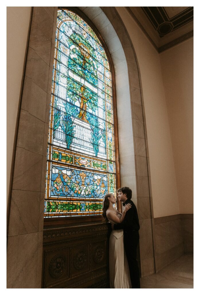 Couple in front of stained glass cathedral window Library Missouri