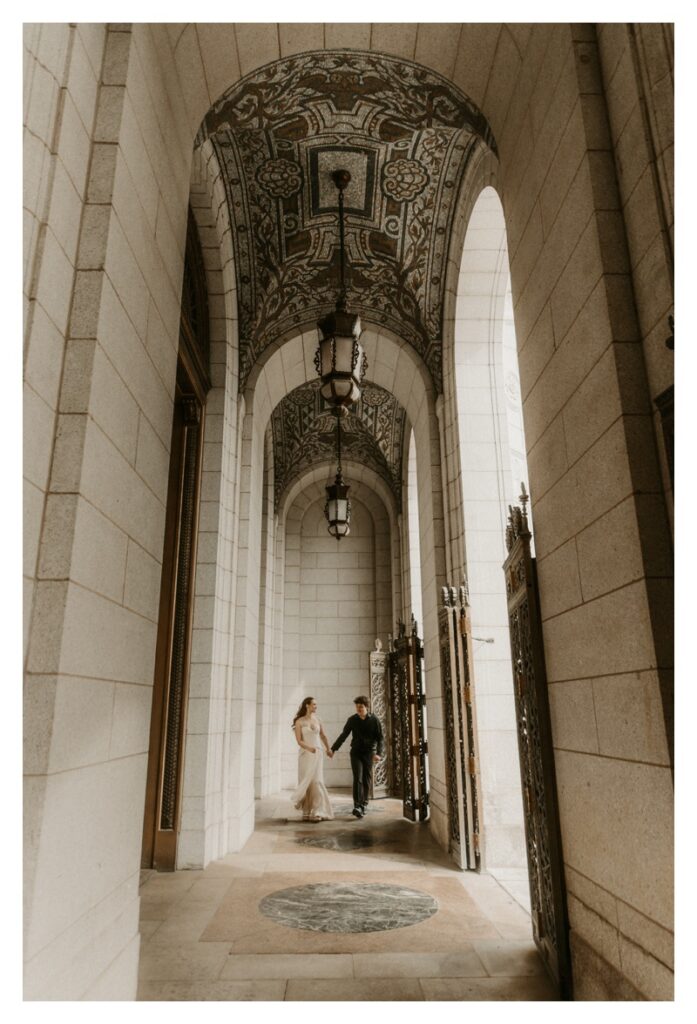 walking shot of engaged couple at St. Louis Central Library