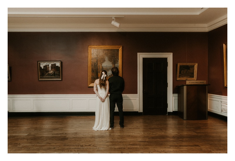 Museum engagement session couples looking at painting moody