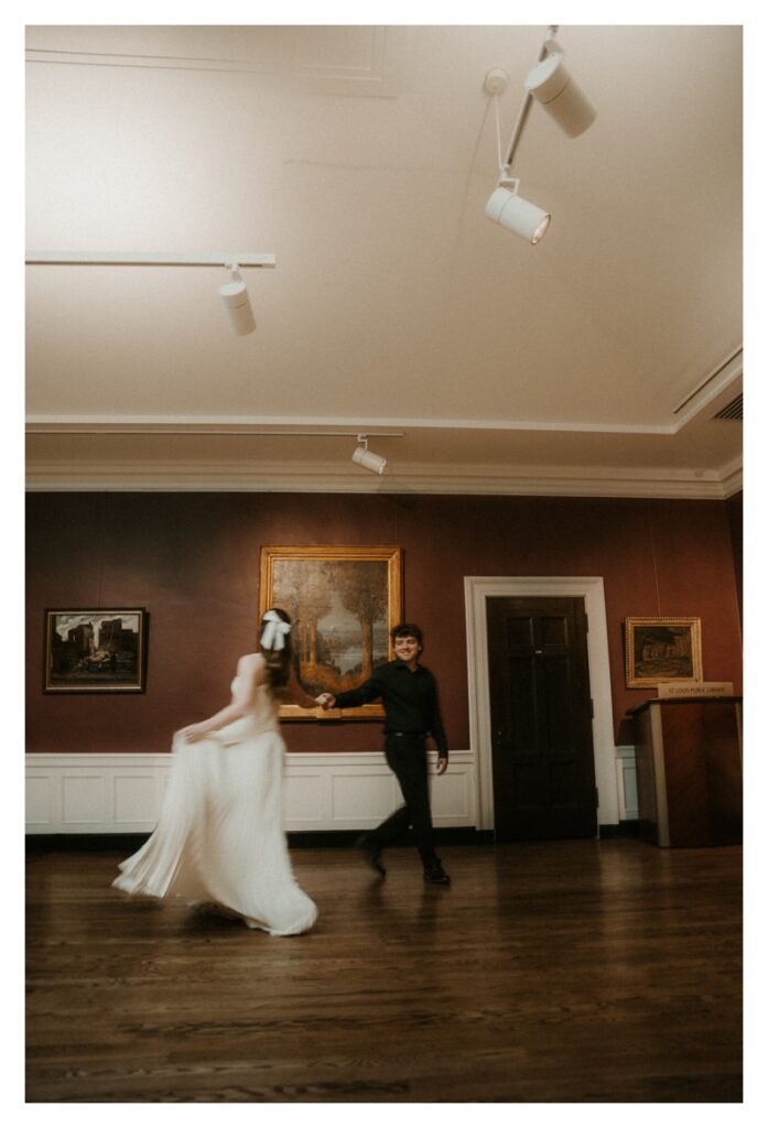 blurry couple dancing in museum vintage engagement photography session