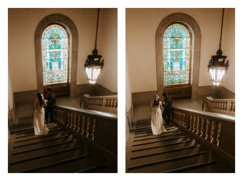 couple walking down vintage staircase engagement session at Central Library in St. Louis Missouri